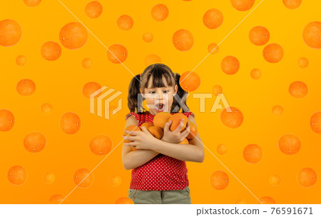 beauty little girl hold many orange 76591671