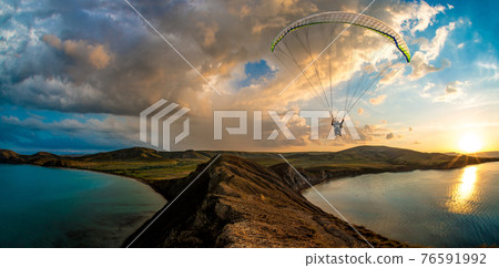 paraglider pilot fly in sky on beauty nature mountain and sea landscape 76591992