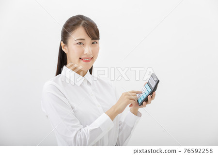 Woman hitting the calculator 76592258