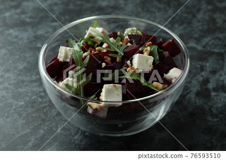 Bowl with fresh beet salad on black smoky background 76593510