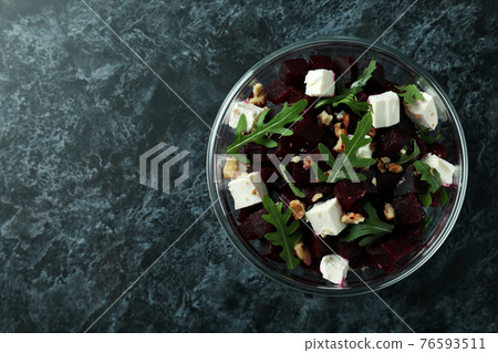 Bowl with fresh beet salad on black smoky background Bowl with fresh beet salad on black smoky background 76593511
