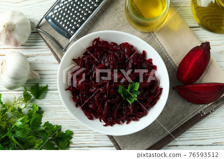 Concept of tasty eating with beet salad on white wooden background Concept of tasty eating with beet salad on white wooden background 76593512