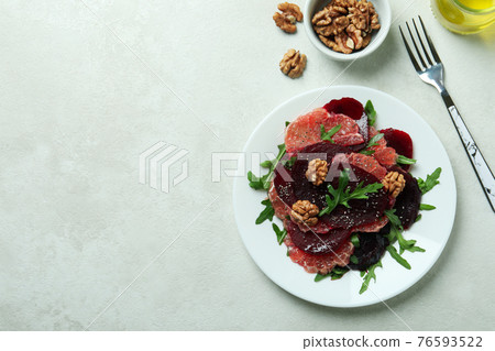 Concept of tasty eating with beet salad on white textured background Concept of tasty eating with beet salad on white textured background 76593522