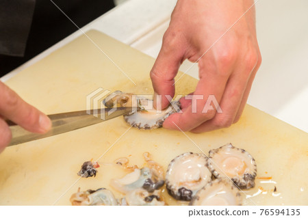 Hands of a man preparing abalone Hands of a man preparing abalone 76594135