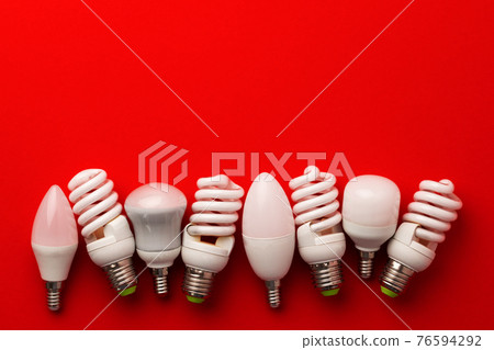 LED light bulbs on red background top view 76594292