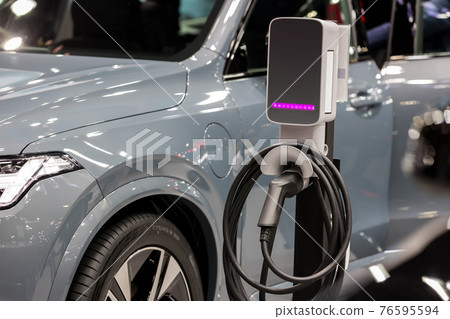 Electric car charging station. Hybrid car Electric charger station in the Car Park. Electric car charging station. Hybrid car Electric charger station in the Car Park. 76595594