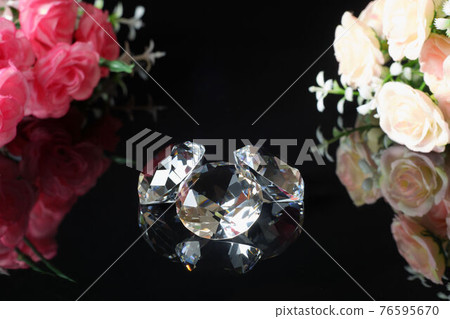Three excellent diamonds of the first water and bouquets of pink and tea roses with reflection on black mirror background close up view. Jewelry diamonds sale, invitation, discount poster template Three excellent diamonds of the first water and bouquets of pink and tea roses with reflection on black mirror background close up view. Jewelry diamonds sale, invitation, discount poster template 76595670
