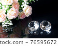 Couple of wonderful pure diamonds and bouquet of tea roses with reflection on black mirror background close up view. Jewelry diamonds sale, invitation, action, discount banner, poster template 76595672