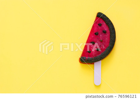 Watermelon popsicle on yellow background. 76596121