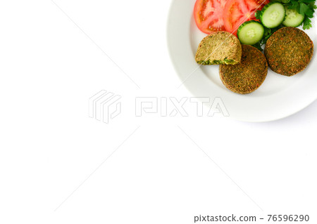 Grilled veggie hamburger with spinach and peas with salad Grilled veggie hamburger with spinach and peas with salad 76596290