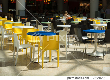 Plastic tables and chairs in a cafe Plastic tables and chairs in a cafe 76596539