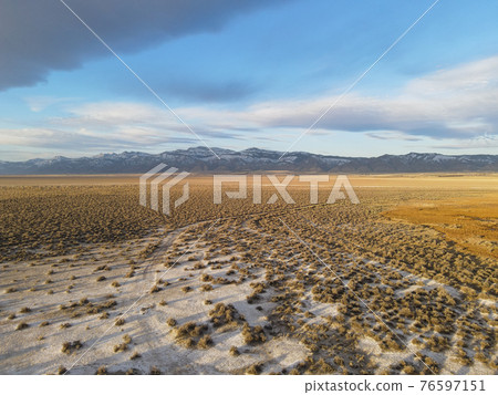 Snow mountains in the background with hot springs on the surprise valley Snow mountains in the background with hot springs on the surprise valley 76597151