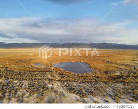 Mountains in the background with hot springs on the surprise valley desert Mountains in the background with hot springs on the surprise valley desert 76597153