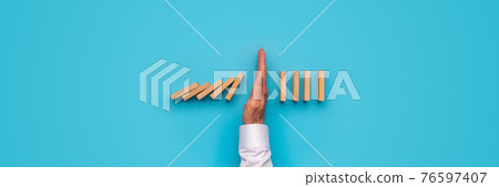 Male hand stopping falling dominos Male hand stopping falling dominos 76597407