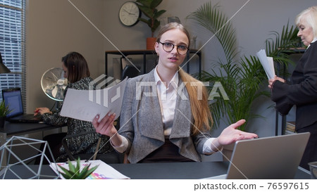 Female business company manager at office reading candidate resume unsuccessful job interview Female business company manager at office reading candidate resume unsuccessful job interview 76597615
