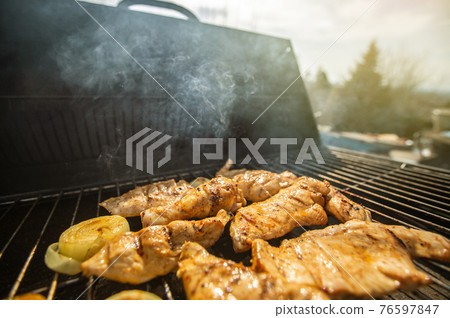 Whole Chicken Grilled On Hot Barbecue Charcoal Flaming BBQ grill with lovely meat smoke, concept of grilling 76597847