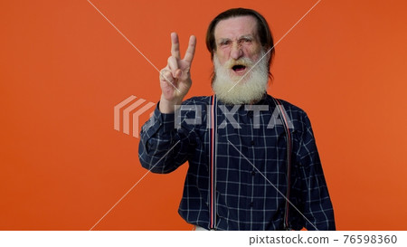 Mature grandfather showing victory sign, hoping for success and win, doing peace gesture, smiling 76598360