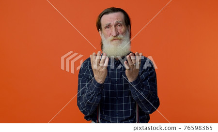 Mature old man praying to God making wish, asking with hopeful imploring expression, begging apology Mature old man praying to God making wish, asking with hopeful imploring expression, begging apology 76598365