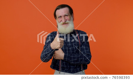 Senior old bearded man raises thumbs up agrees with something or gives positive reply likes good Senior old bearded man raises thumbs up agrees with something or gives positive reply likes good 76598393