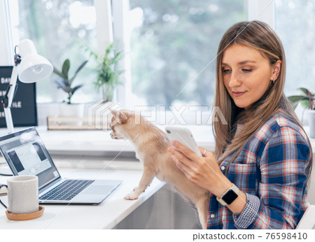 woman with dog, laptop and mobile phone woman with dog, laptop and mobile phone 76598410