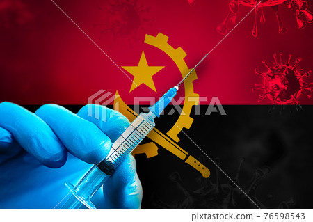 Angola Covid-19 Vaccination Campaign. Hand in a blue rubber glove holds a syringe with covid-19 virus vaccine in front of Angola flag 76598543