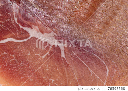 Jamon or dry-cured ham produced in Spain texture close up. Food background 76598568