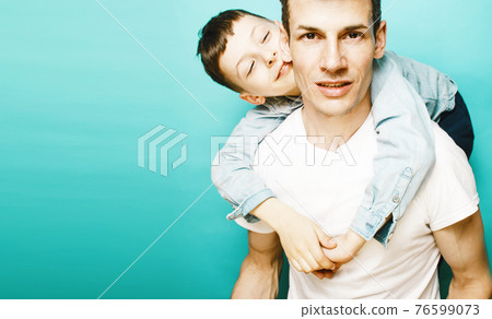 young pretty man model with little cute son playing together, lifestyle modern people concept, family male young pretty man model with little cute son playing together, lifestyle modern people concept, family male 76599073