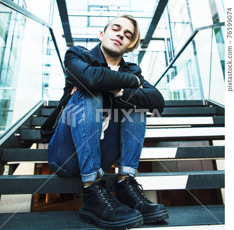 young modern hipster guy at new building university blond fashion handsome boy, lifestyle people concept young modern hipster guy at new building university blond fashion handsome boy, lifestyle people concept 76599074