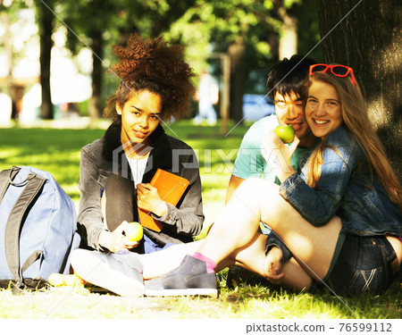 cute group of teenages at the building of university with books huggings, diversity nations cute group of teenages at the building of university with books huggings, diversity nations 76599112