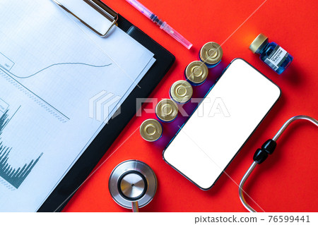 Medical equipment. Doctor stethoscope, healthcare charts, syringe with needle and black smartphone with blank screen on hospital red background. For design application, website project. Medical equipment. Doctor stethoscope, healthcare charts, syringe with needle and black smartphone with blank screen on hospital red background. For design application, website project. 76599441