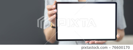 Female hands hold tablet with white screen 76600170