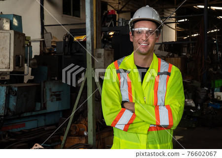 Young skillful factory worker or engineer close up portrait in factory Young skillful factory worker or engineer close up portrait in factory 76602067