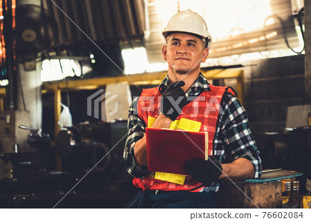 Manufacturing worker working with clipboard to do job procedure checklist . Manufacturing worker working with clipboard to do job procedure checklist . 76602084