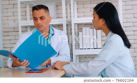 Doctor in professional uniform examining patient at hospital 76602104