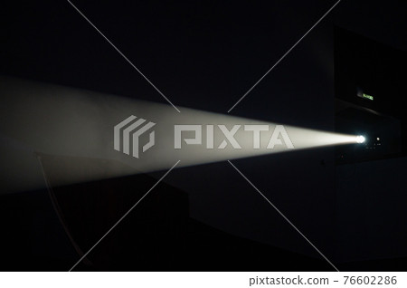 Multi-color light on dark stage in fog 76602286