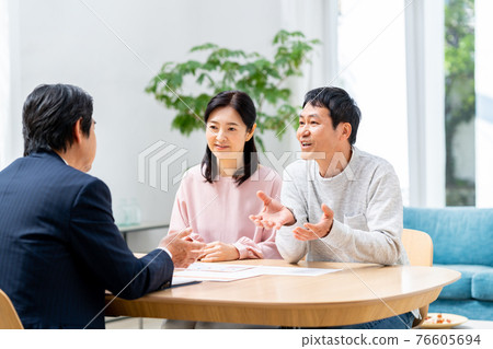 Middle-aged couple consulting with a planner 76605694