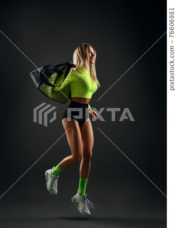 Happy laughing young sporty blonde fitness woman 76606981