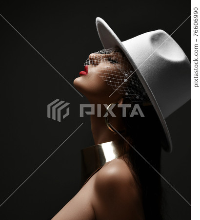 Profile of rich woman in white hat with veiling Profile of rich woman in white hat with veiling 76606990