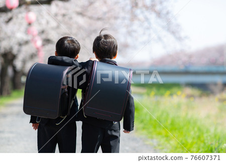 Cute children entering elementary school Cute children entering elementary school 76607371