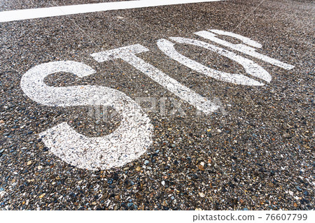 STOP a large inscription on the asphalt in full screen STOP a large inscription on the asphalt in full screen 76607799