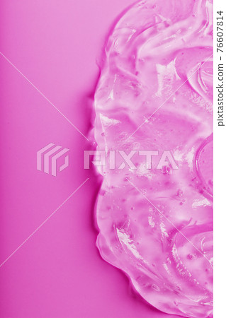 Transparent liquid gel on a pink background with free space. Transparent liquid gel on a pink background with free space. 76607814
