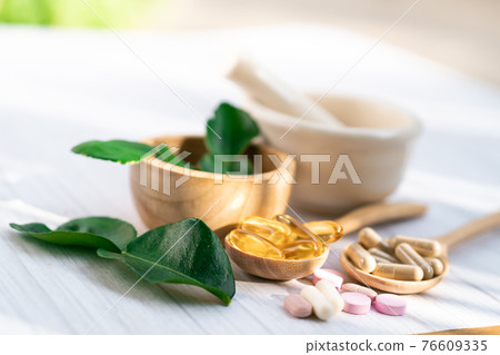 Alternative medicine herbal organic capsule with vitamin E omega 3 fish oil, mineral, drug with herbs leaf natural supplements for healthy good life. 76609335