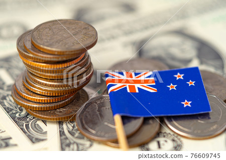 Stack of coins with Australia flag on USA America dollar banknotes. Stack of coins with Australia flag on USA America dollar banknotes. 76609745