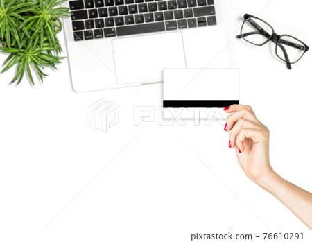Online shopping Female hand holding credit card flatlay Online shopping Female hand holding credit card flatlay 76610291