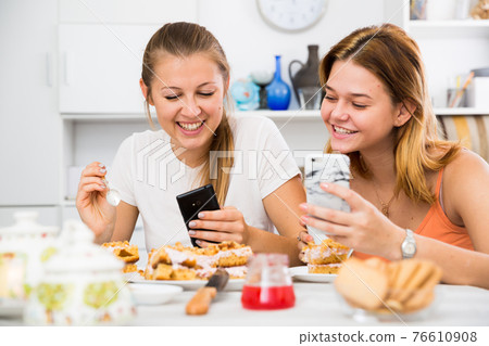 friends drinking tea with mobile phone friends drinking tea with mobile phone 76610908