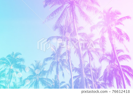 Tropical palm coconut trees on sunset sky flare and bokeh nature background. Tropical palm coconut trees on sunset sky flare and bokeh nature background. 76612418