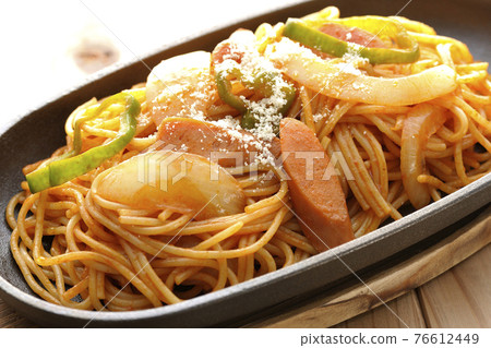 Napolitan with onions, peppers and wieners served on an iron plate 76612449