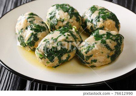 Italian Bread gnocchi with spinach known as Strangolapreti close-up in a plate. Horizontal 76612990