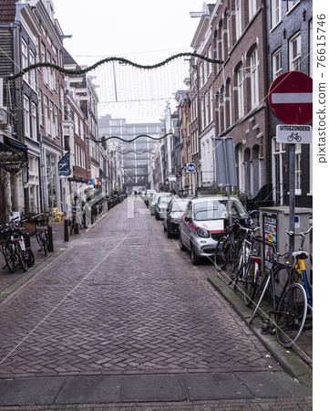 On the street walking people and moving vehicles 76615746