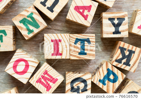 Alphabet letter block in word IT (Abbreviation of information technology) with another on wood background 76616570